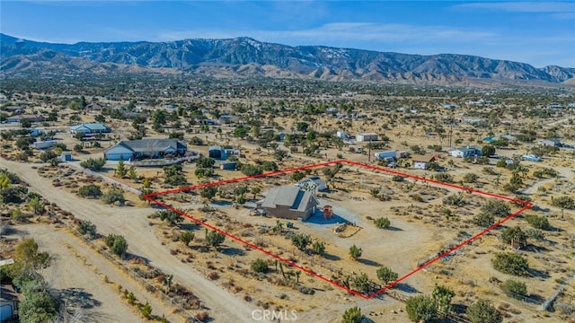 birds eye view of property with a mountain view