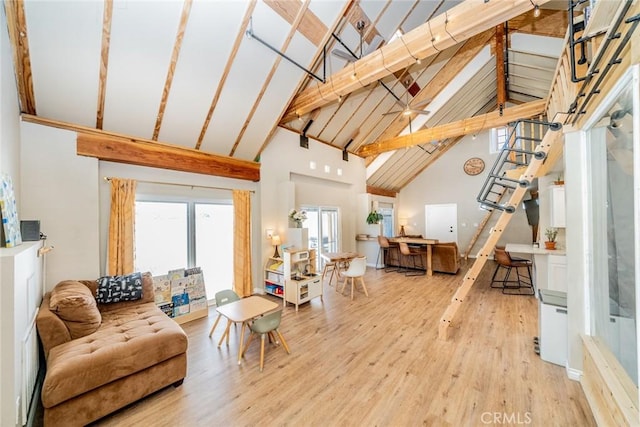 living room with hardwood / wood-style flooring, beam ceiling, and high vaulted ceiling