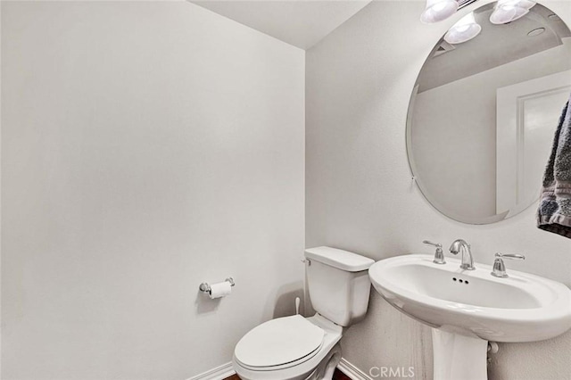 bathroom with toilet and sink