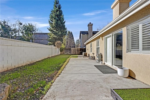 view of yard featuring cooling unit and a patio