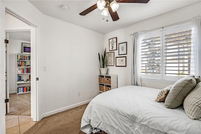 bedroom with ceiling fan and light colored carpet