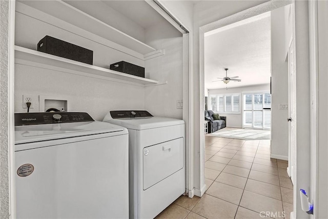 washroom with washer and clothes dryer, ceiling fan, and light tile patterned flooring