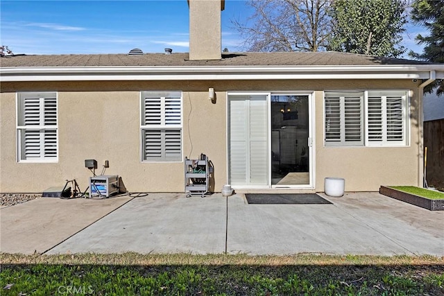 back of property with a patio