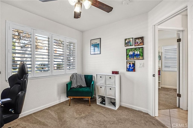 interior space with light colored carpet and ceiling fan