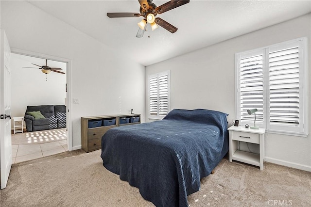 bedroom featuring lofted ceiling, light colored carpet, and ceiling fan