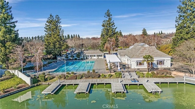 exterior space with a fenced in pool and a water view