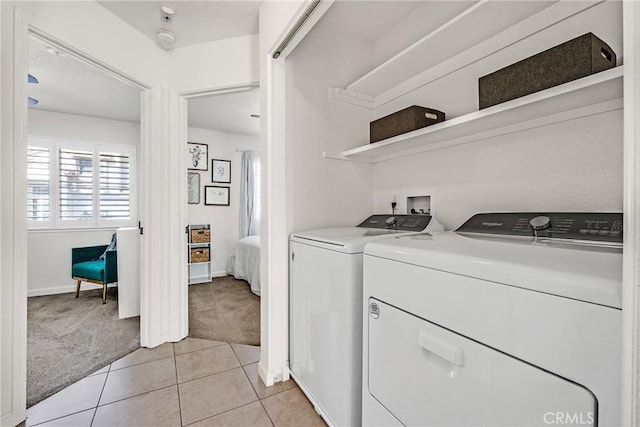 washroom with washer and dryer and light carpet