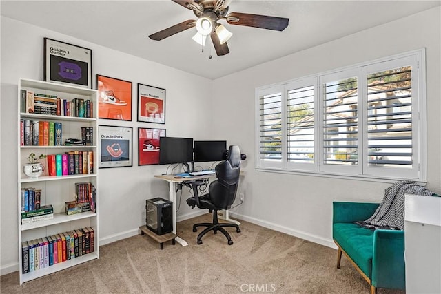 carpeted office space with ceiling fan