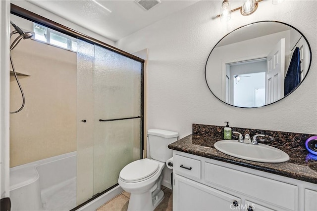 bathroom with vanity, tile patterned flooring, a shower with door, and toilet