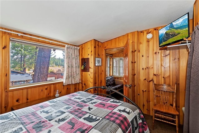 carpeted bedroom with wooden walls