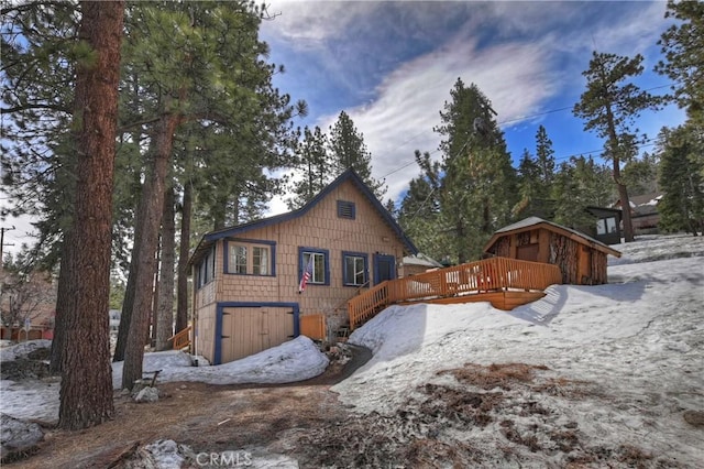 snow covered property featuring a deck