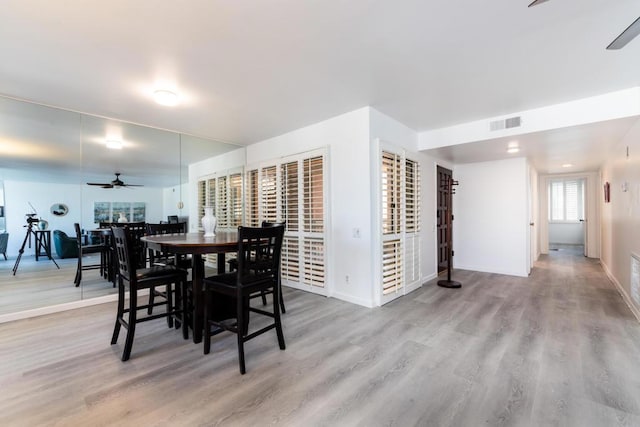 dining area featuring ceiling fan and light wood-type flooring