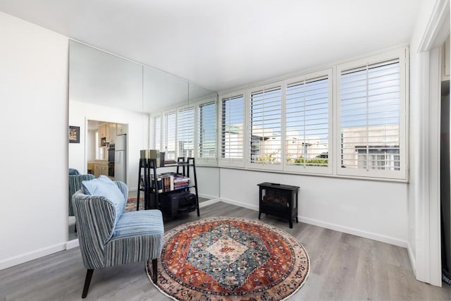 sitting room with wood-type flooring