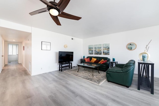 living room with ceiling fan and light hardwood / wood-style flooring