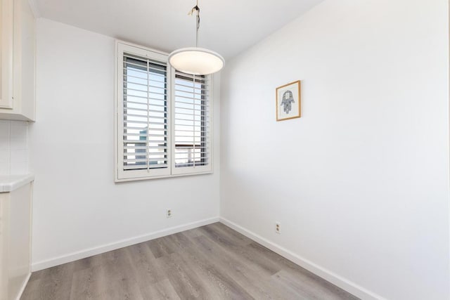 unfurnished dining area featuring light wood-type flooring