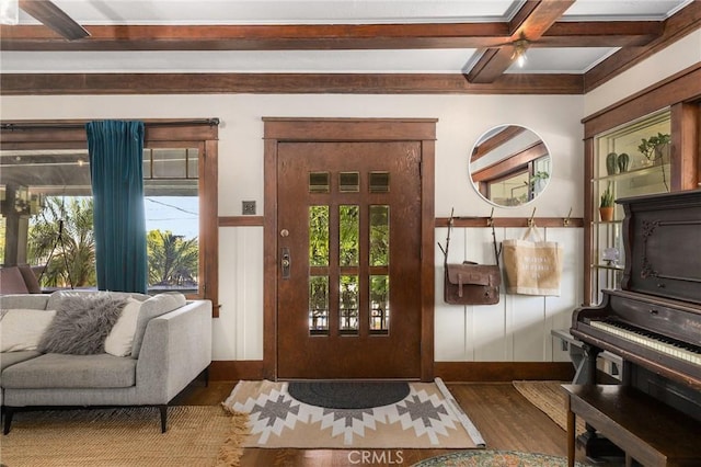 interior space with coffered ceiling, dark hardwood / wood-style floors, a wealth of natural light, and beam ceiling