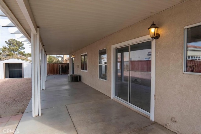 view of patio featuring a storage unit