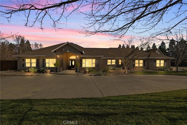 ranch-style home with a lawn