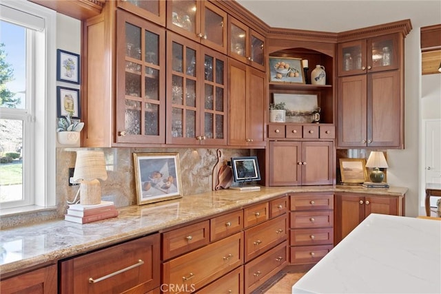 kitchen with light stone countertops and a healthy amount of sunlight