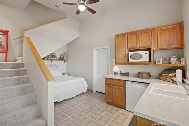 kitchen with ceiling fan, sink, and white appliances