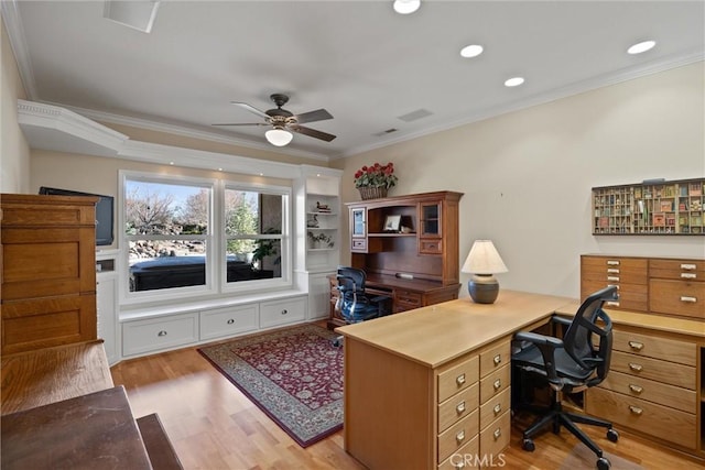 home office with crown molding, ceiling fan, and light hardwood / wood-style flooring