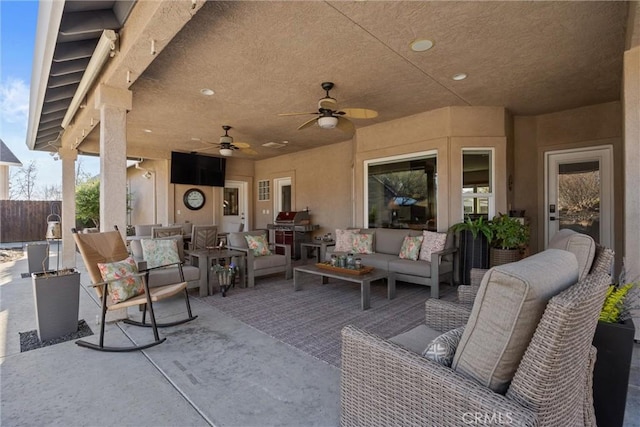 view of patio with an outdoor living space and ceiling fan