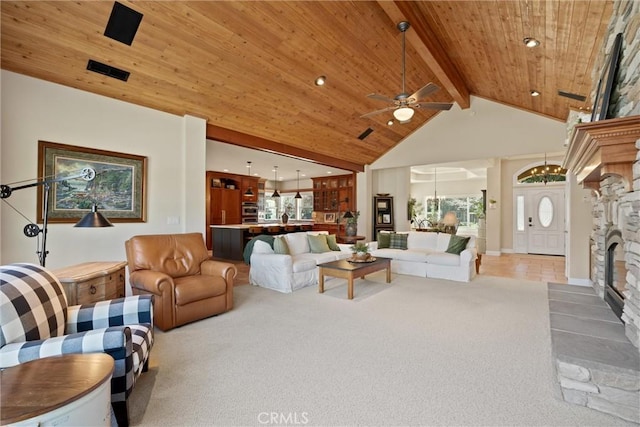 living room featuring high vaulted ceiling, carpet, a stone fireplace, wooden ceiling, and beamed ceiling