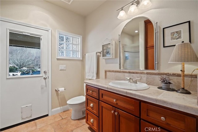 bathroom featuring tile patterned flooring, vanity, and toilet