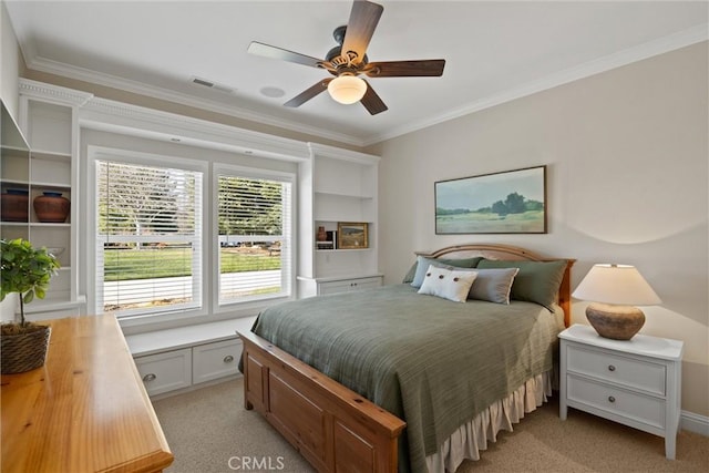 carpeted bedroom featuring ornamental molding and ceiling fan