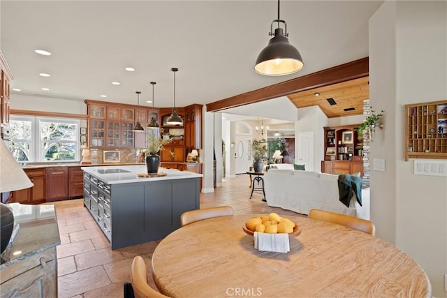 dining space with lofted ceiling, light tile patterned floors, and a chandelier