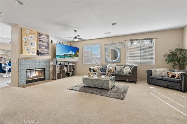 living room with a fireplace, ceiling fan, and carpet