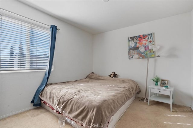 bedroom with multiple windows and carpet