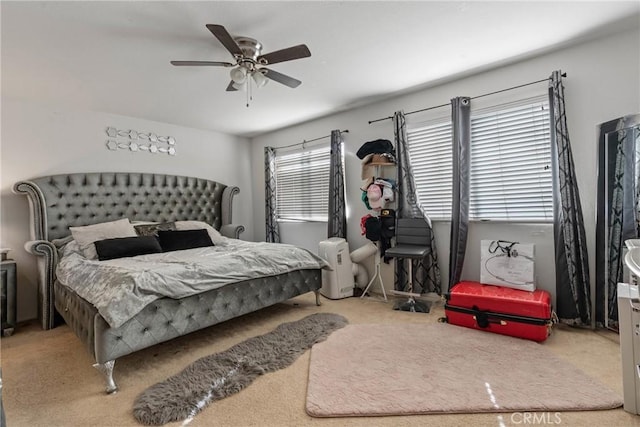 bedroom with light colored carpet and ceiling fan