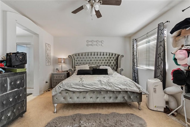 bedroom with ceiling fan and light colored carpet