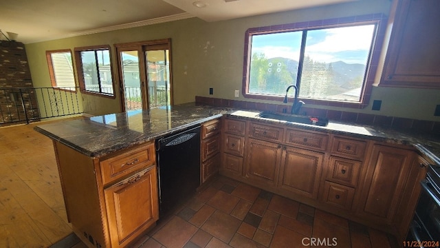 kitchen featuring black appliances, sink, dark stone countertops, ornamental molding, and kitchen peninsula