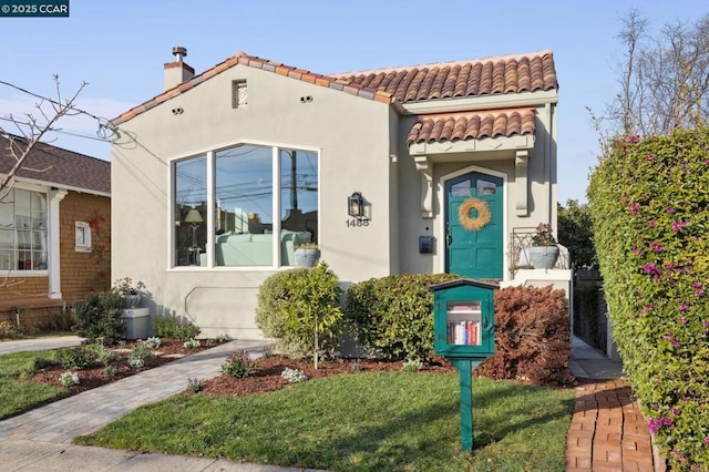 mediterranean / spanish-style house with a front yard