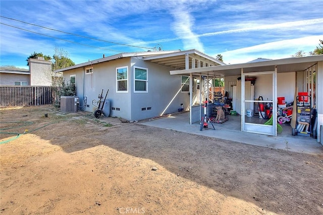 rear view of house featuring a patio and central AC unit