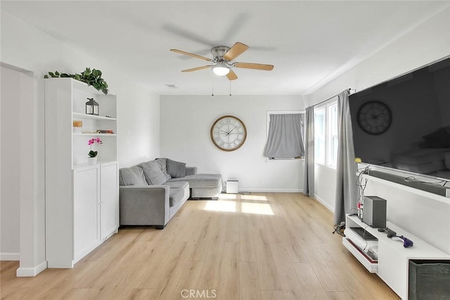 living room with ceiling fan and light hardwood / wood-style flooring