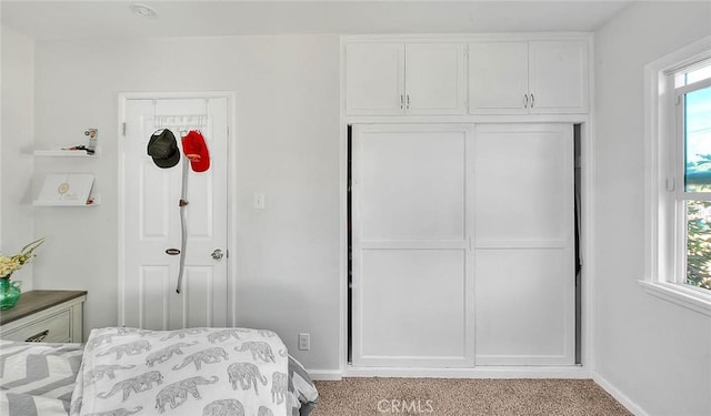 bedroom featuring light colored carpet