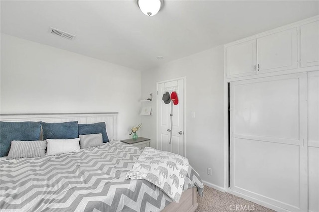 bedroom featuring light carpet