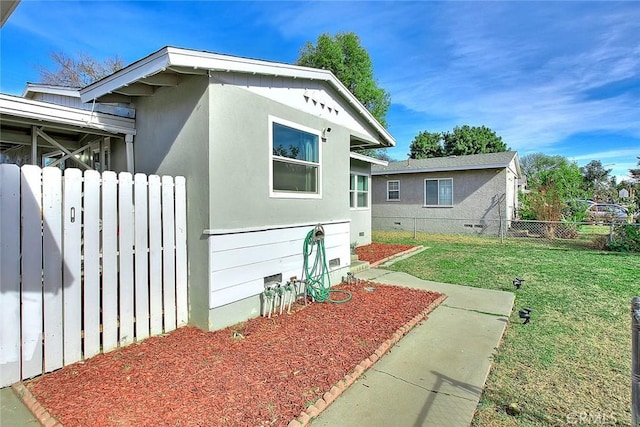 view of home's exterior with a lawn