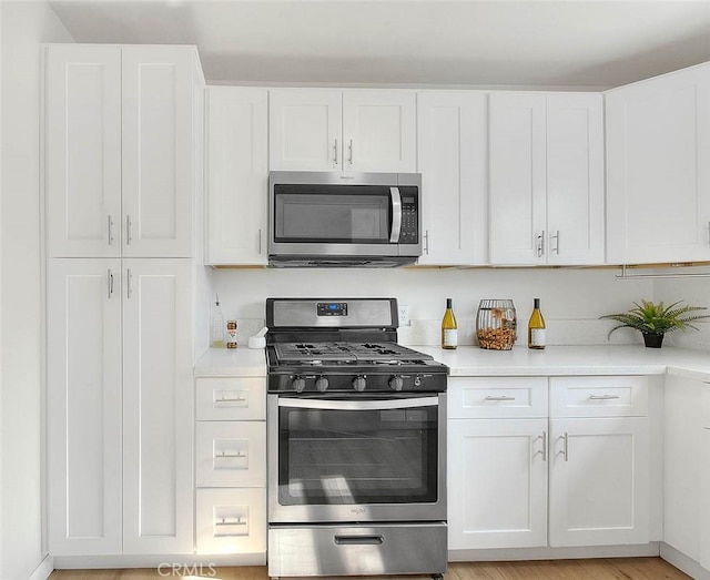 kitchen featuring appliances with stainless steel finishes and white cabinets