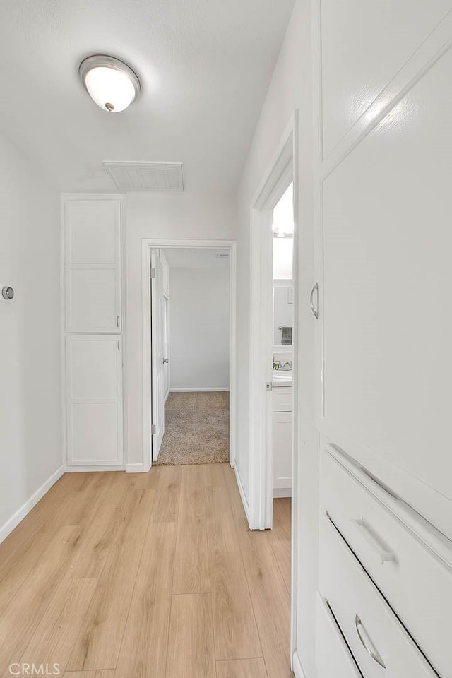 hall with light hardwood / wood-style flooring