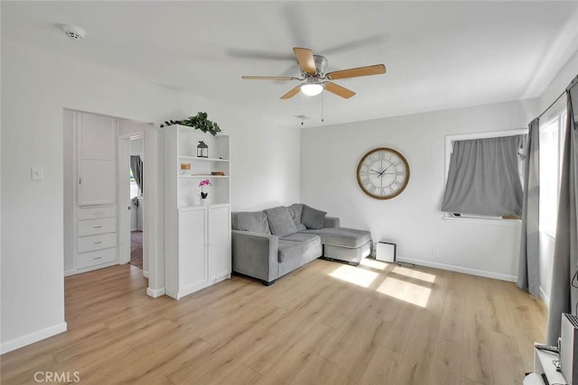 unfurnished living room with ceiling fan and light wood-type flooring