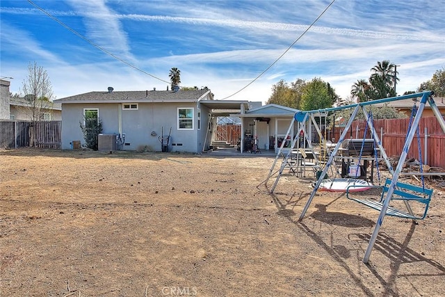 back of house with cooling unit and a playground