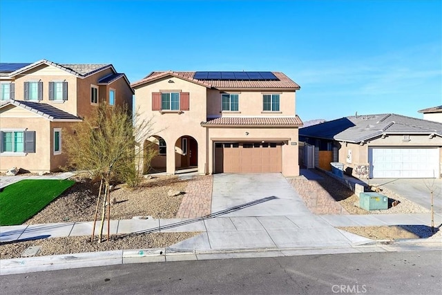 view of front facade with a garage and solar panels