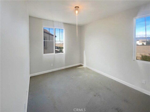 unfurnished room featuring concrete flooring