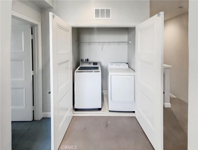 laundry area with separate washer and dryer and carpet floors