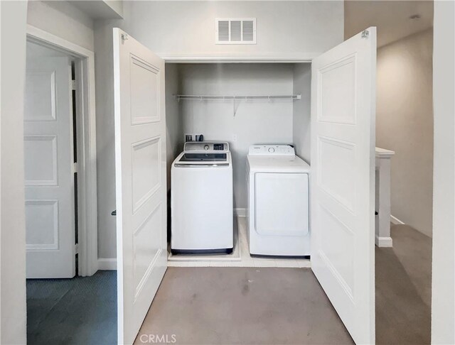 clothes washing area with washer and clothes dryer