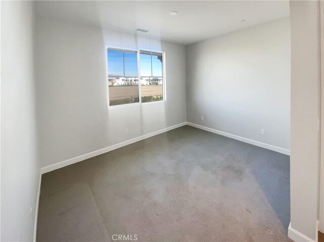 empty room with dark colored carpet